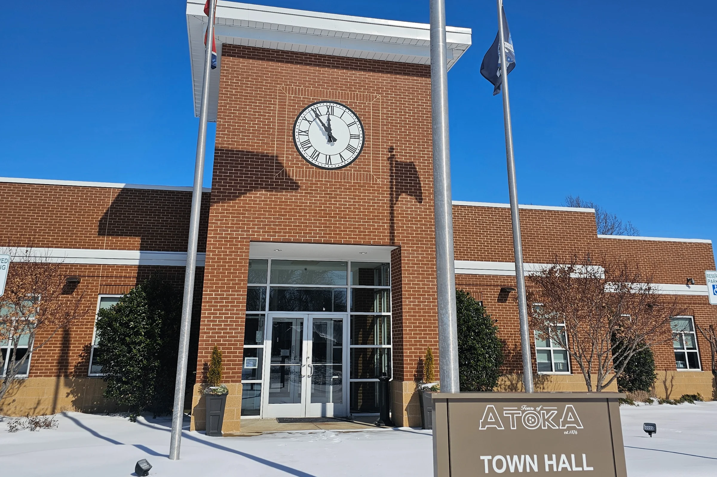 Atoka, Tennessee Town Hall building in winter with American flags and clock tower
